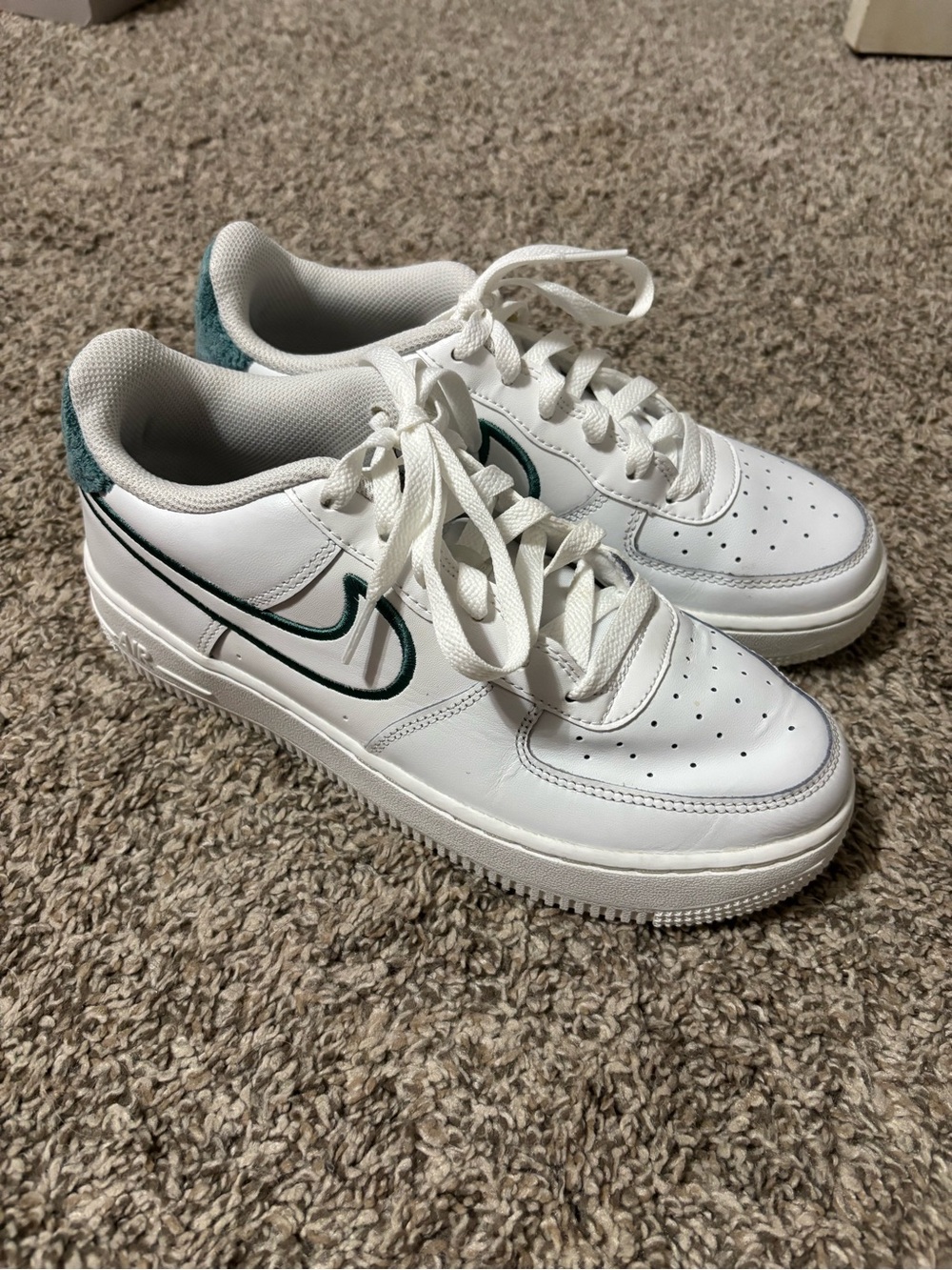 Nike Air Force 1 shoes with green accents